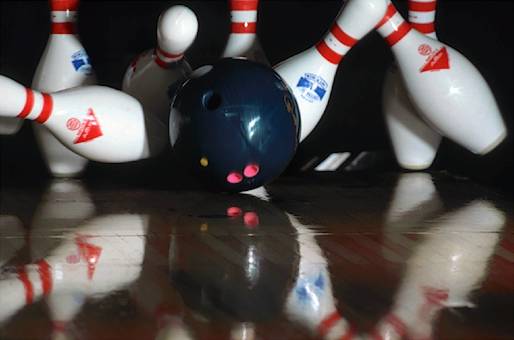 Bowling ball striking pins 